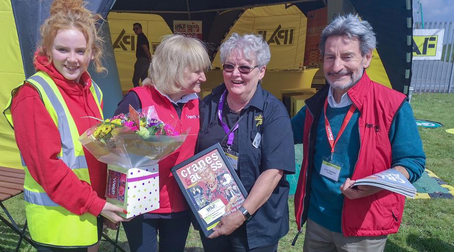 Jean Harrison at Vertikal Days 2019 at Donington Park, given a special send-off including a framed commemorative front cover of Cranes & Access magazine by event organisers.